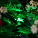 Green LED lighting among the wreath leaves and white flowers on Christmas Table Decoration 40743