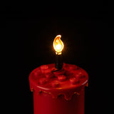Angled close-up of the illuminated candle flame and red candle on Christmas Table Decoration 40743