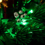 Close-up of white flowers and green lighting in the Christmas Table Decoration 40743 wreath